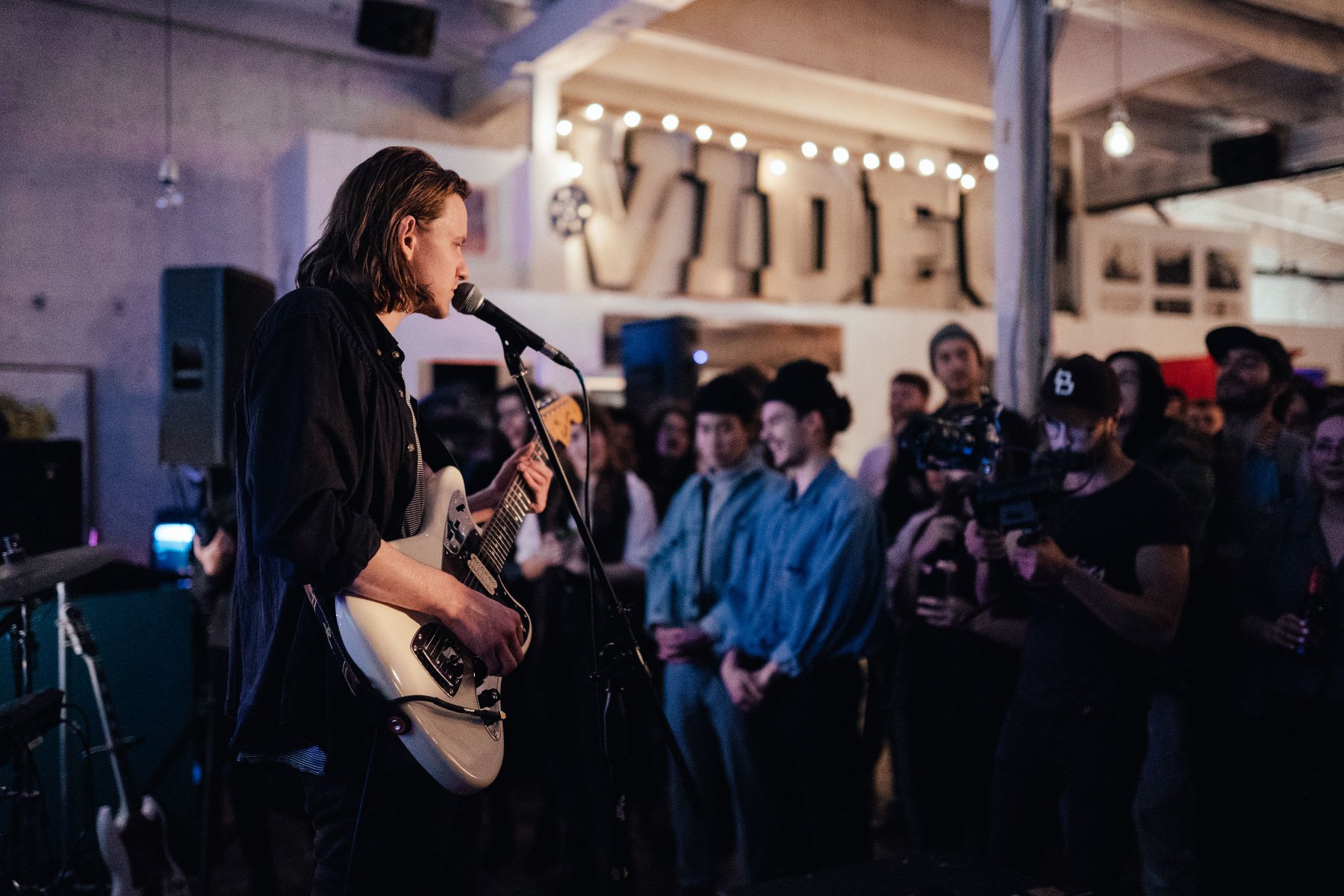 Vince James performing on stage infront of the audience.
